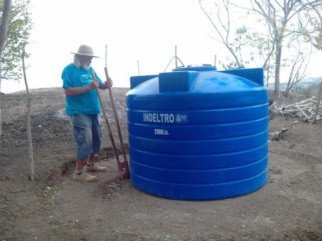 Digging posts to secure water tank